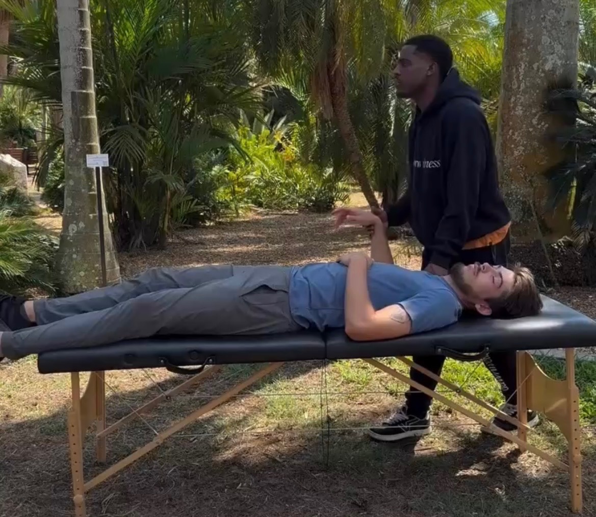 Luke Stokes performing assisted stretching